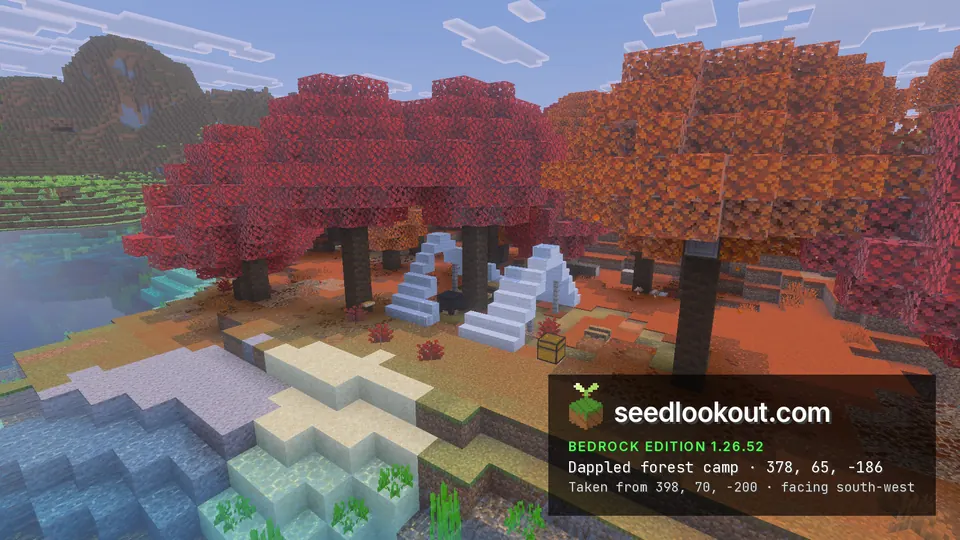 White wool tent with a chest and cauldron under red and orange trees on a riverbank, a mountain behind