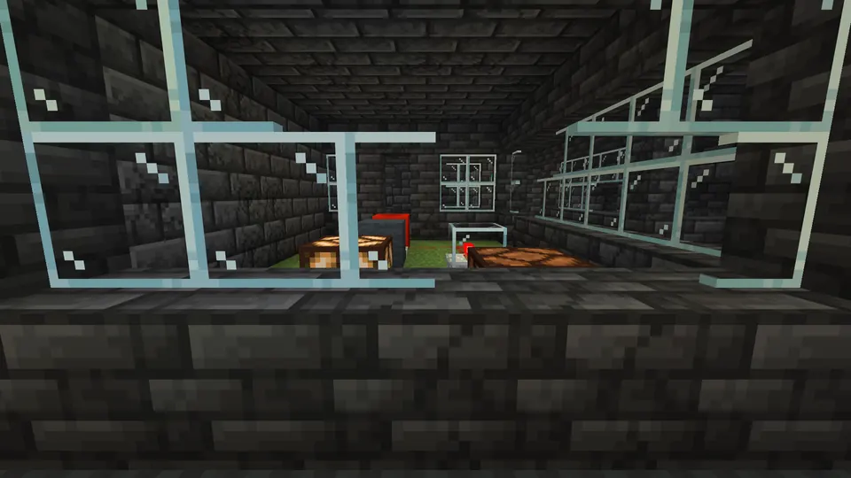 Deepslate brick room seen through glass panes, with a moss floor inside