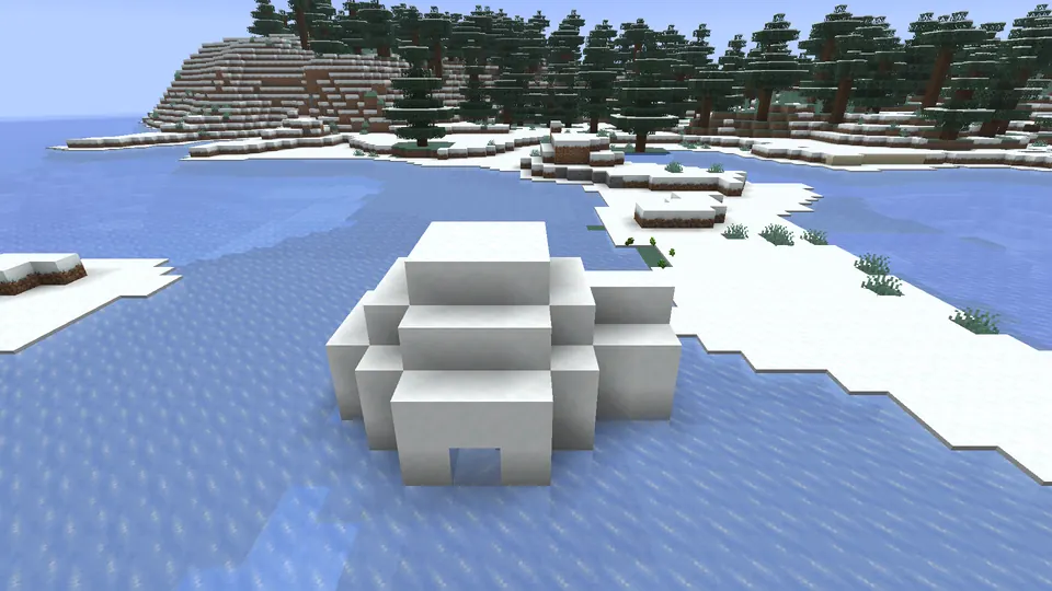 Igloo z bloków śniegu z wejściem skierowanym ku zamarzniętej linii brzegowej
