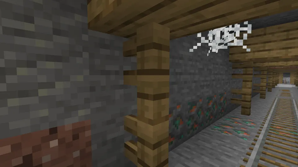 Mine rails and wooden supports in a natural mineshaft passage