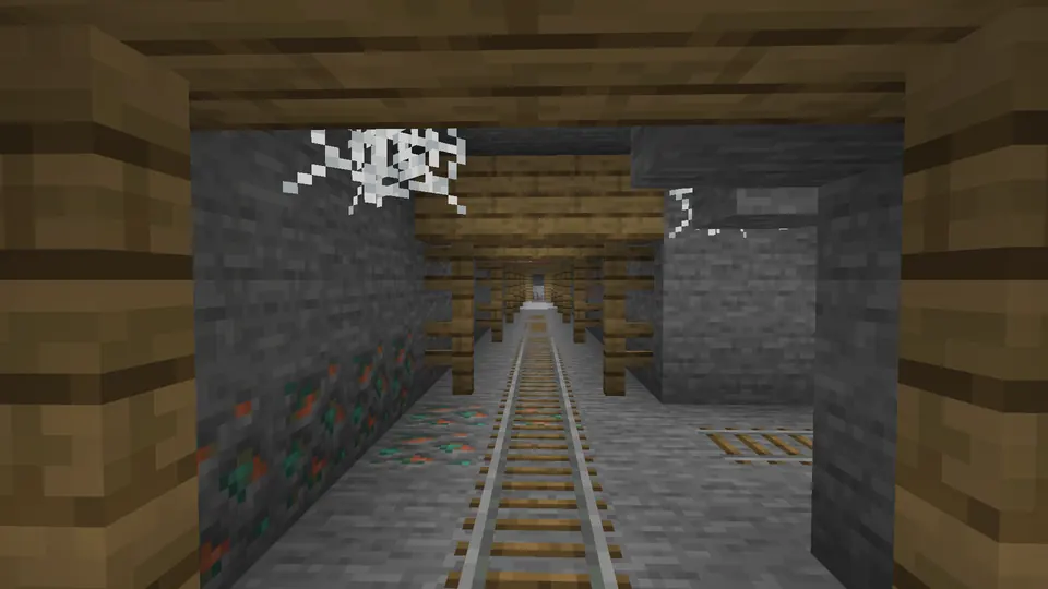 Rails and cobwebs beneath oak support beams in an underground mineshaft corridor