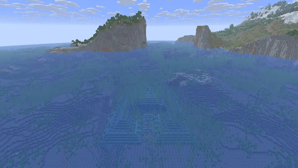 Prismarine ocean monument under blue water, steep rocky islands with forest behind