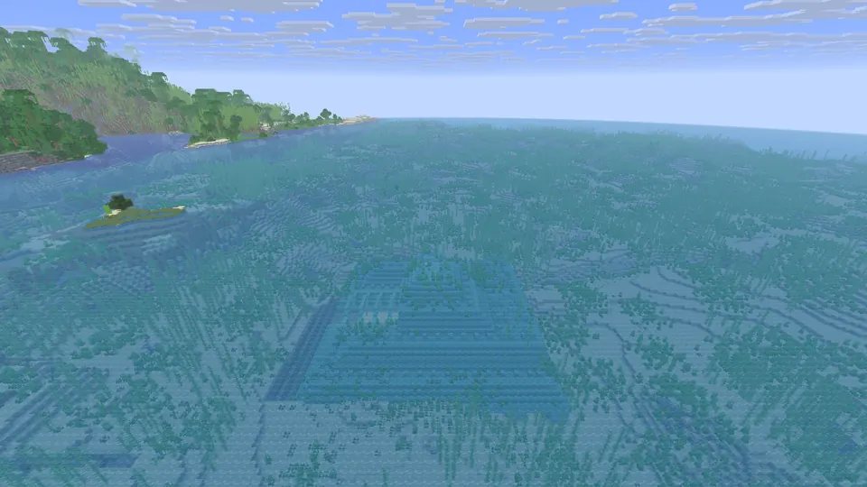 Ocean monument outline on the sea floor under clear water, a wooded shore and small islet behind