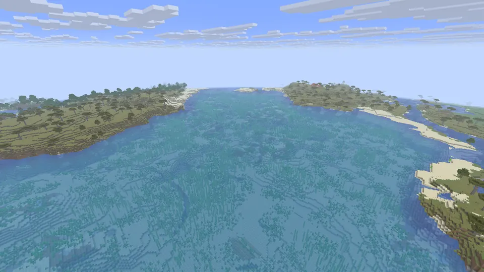 Shallow blue channel between two savanna islands with sandy beaches