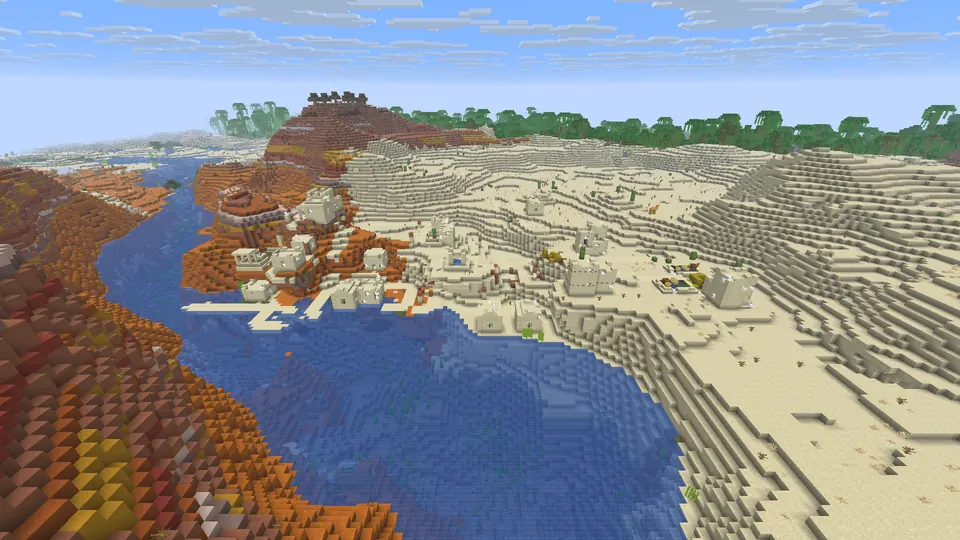 Sandstone village houses on sand dunes beside a blue river, orange terracotta banks and jungle on the horizon